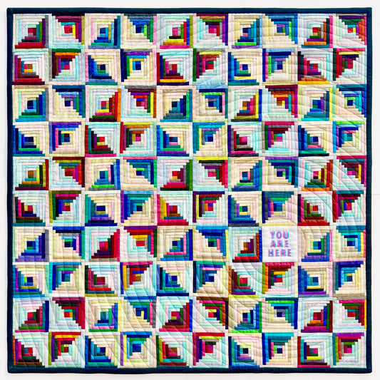 Colorful quilt with geometric pattern on a white background
